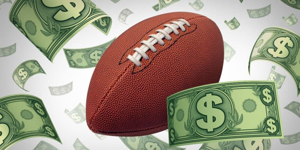 A football is surrounded by a bunch of dollar bills